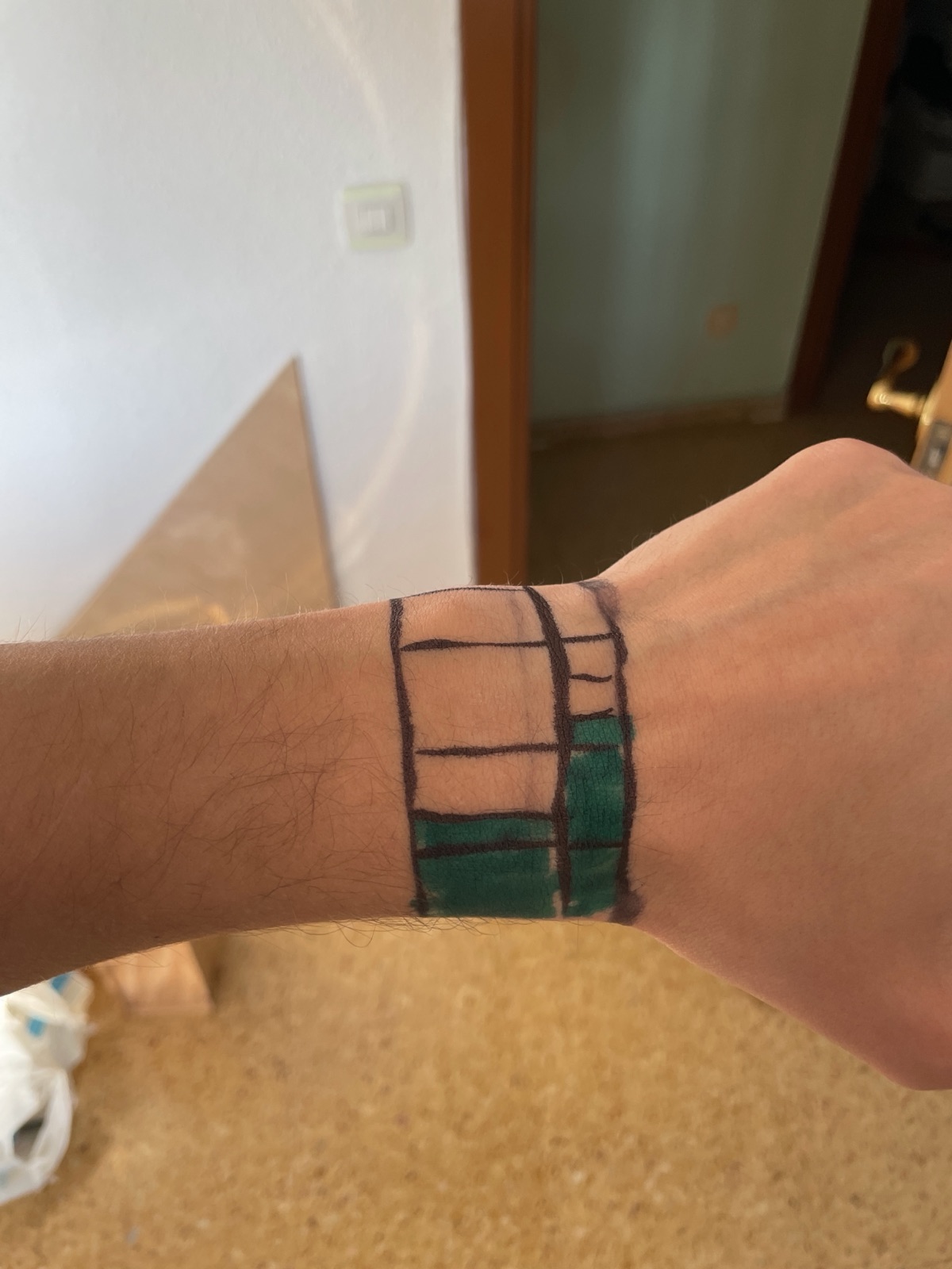The block pattern drawn directly on a wrist in marker