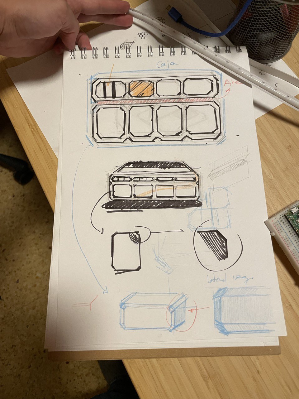 The desk sketch: block layouts and chassis studies in a notebook