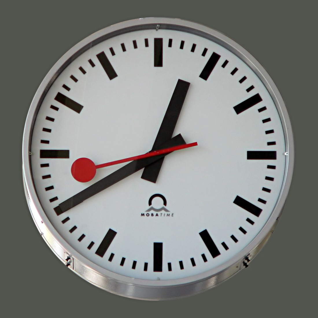 The Swiss railway clock face: bar markers, red lollipop second hand