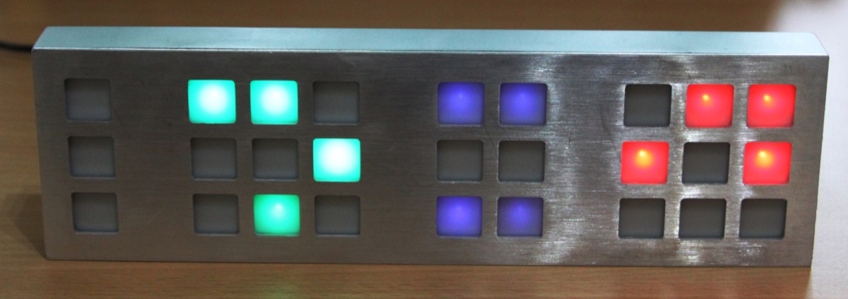 A TIX clock: LED squares in groups, the count of lit squares reading the digits